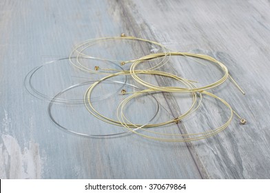 Acoustic Guitar Strings Isolated On Ancient Wood Background