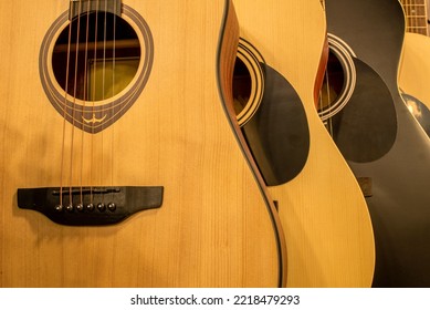 Acoustic Guitars Hang In A Row In A Music Store. Guitars Close-up