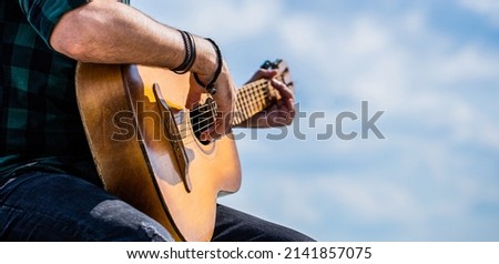 Acoustic guitars playing. Music concept. Guitars acoustic. Male musician playing guitar, music instrument. Man's hands playing acoustic guitar, close up.