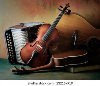 Acoustic musical instruments guitar ukulele violin and accordion with vintage book lay on fine painted floor and backdrop for wall web interior decoration still life style - Powered by Shutterstock