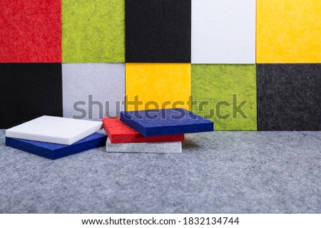 Acoustic panels in red, blue, green, yellow, gray, white, black colors