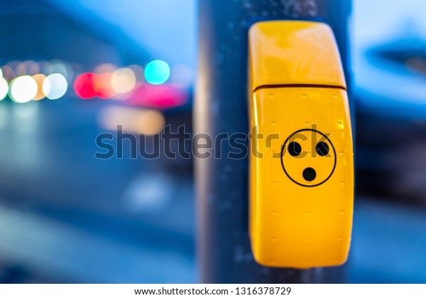 Acoustic signal generator for blind people at\
traffic light post in the\
evening.