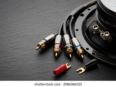 Acoustic speaker with connectors, electrical plugs for speaker wires with, connectors close-up on a black background