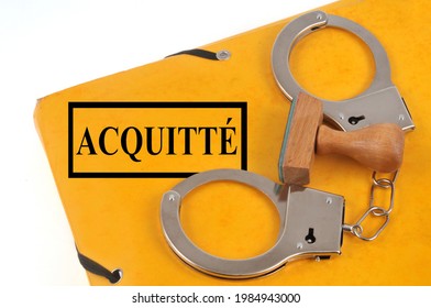 Acquittal File With Handcuffs And An Ink Pad