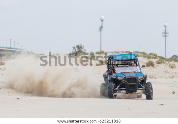 Acre, Israel - April 15, 2015 : Young man drives\
extreme on his off-road vehicle along the Mediterranean sea coast\
near Acre, Israel