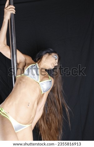 Acrobat on a pole doing aerial stunts