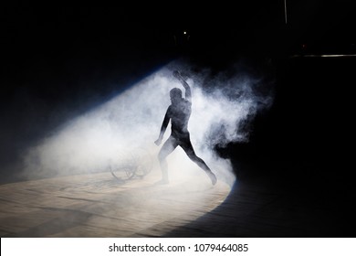 Acrobat performs a difficult trick in the circus. - Powered by Shutterstock
