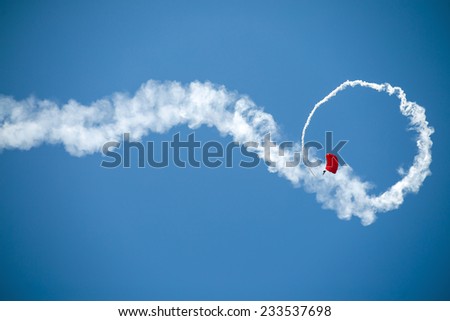 Similar – Red plane with propeller flying upward with white smoke