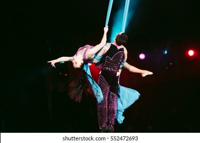 Acrobats performs a difficult trick in the circus.