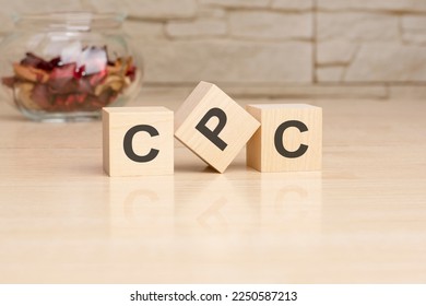 Acronym CPC - Cost per Click. Wooden small cubes with letters on wooden table. business concept image.