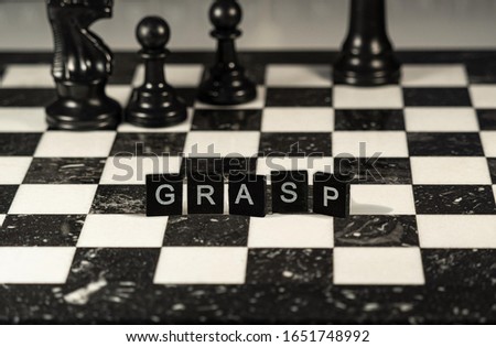 the acronym grasp for General Responsibility Assignment Software Patterns concept represented by wooden letter tiles