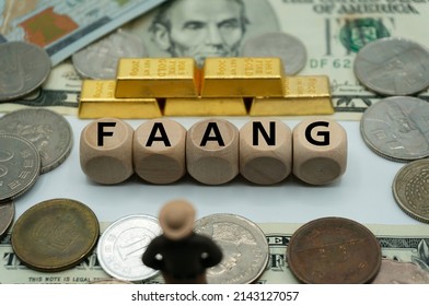 “FAANG” is an acronym that refers to the stocks of five prominent American technology company.widely known among consumers,The word is written,on  money and gold background