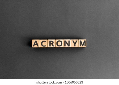 acronym - word from wooden blocks with letters, use of acronyms in the modern world abbreviation concept, random letters around, top view on wooden background - Shutterstock ID 1506955823