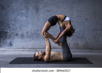 Acroyoga practice, man on woman on a urban background - Powered by Shutterstock