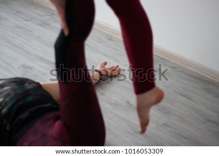 Acroyoga for two. Couple training together and taking yoga asanas. Details of their hands and legs. Balance and trust for two. Perfect form. 