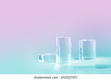 Acrylic empty podium for product presentation on nein pink and blue colored background, transparent geometric pedestals