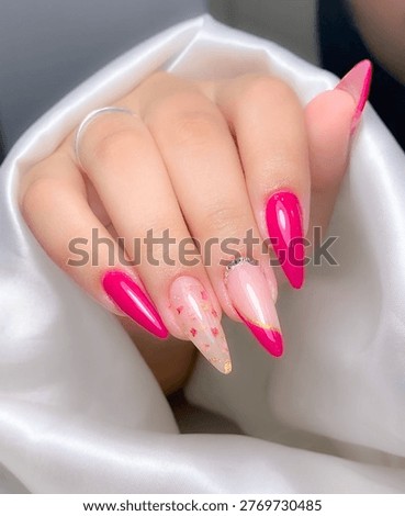 Acrylic Nails in Pink with Cute Patterns. Professional stock photo of a model’s hand featuring acrylic nails in pink shades with lovely nail art details. cute nail art