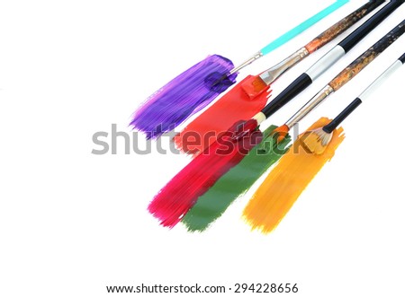 Acrylic paints and art brushes on a white background with copy space for text