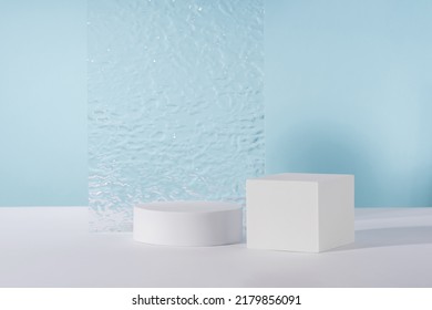 Acrylic plate, podium, background for cosmetic product packaging on blue backdrop with stylish props. Showcase for jewellery presentation, display for advertising, cosmetics branding scene mockup