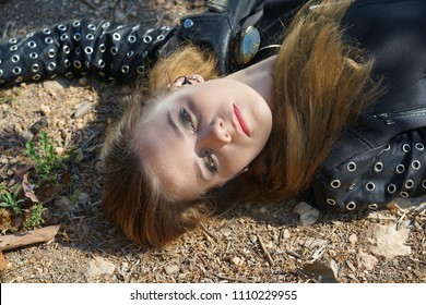 Acting crime scene - female victim lying dead on the dirty ground