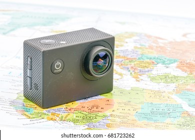 Action camera with map background. Travel and planning concept.