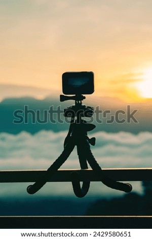 Action camera on tripod capturing time-lapsed video.
