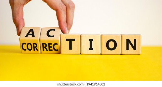 Action or correction symbol. Businessman turns wooden cubes and changes the word correction to action. Beautiful yellow table, white background, copy space. Business and action or correction concept.