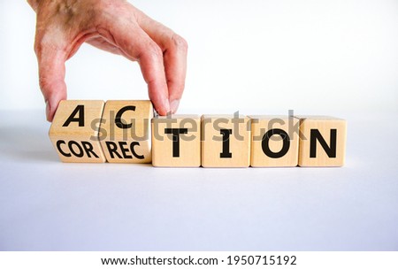 Action or correction symbol. Businessman turns wooden cubes and changes the word correction to action. Beautiful white background, copy space. Business and action or correction concept.