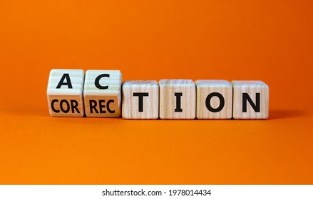 Action or correction symbol. Turned wooden cubes and changed the word correction to action. Beautiful orange background, copy space. Business and action or correction concept.