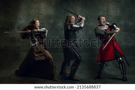 In action. Creative art collage with brutal serious medieval warriors or knights war clothes with wounded faces holding shield, sword isolated over vintage background. Comparison of eras, history