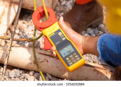 Action Of Electrician Using Ohm Meter To Measure Electric Earthing Ground Resistance. Industrial And Technology Equipment Concept Photo.