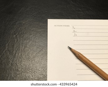 Action Items Write Down On Notebook By Pencil Put On Black Leather Table