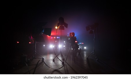 Action Movie Concept. Police Cars And Miniature Movie Set On Dark Toned Background With Fog. Police Car Chasing A Car At Night. Scene Of Crime Accident. Selective Focus