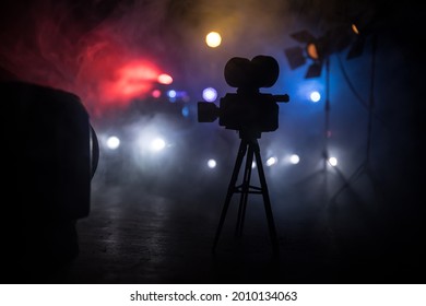 Action Movie Concept. Police Cars And Miniature Movie Set On Dark Toned Background With Fog. Police Car Chasing A Car At Night. Scene Of Crime Accident. Selective Focus