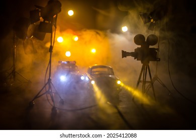 Action Movie Concept. Police Cars And Miniature Movie Set On Dark Toned Background With Fog. Police Car Chasing A Car At Night. Scene Of Crime Accident. Selective Focus