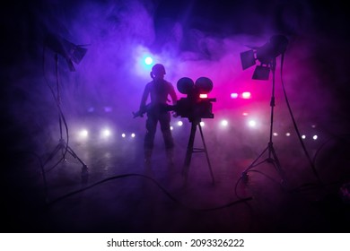 Action Movie Concept. Police Cars And Miniature Movie Set On Dark Toned Background With Fog. Police Car Chasing A Car At Night. Scene Of Crime Accident. Selective Focus