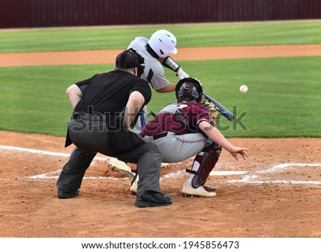 Action photo of high school baseball players making amazing plays during a baseball game