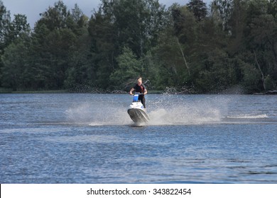 Action Photo Young Woman On Jet Ski.
