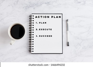 Action Plan Plan, Execute, Succed writing on notebook. Notebook on desk with coffee cup and a pen.