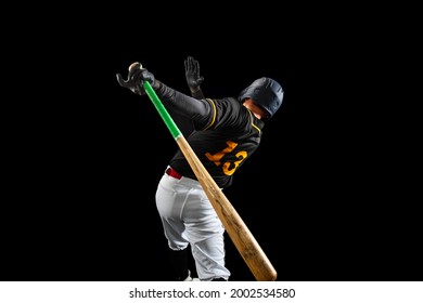 In Action. Professional Baseball Player, Pitcher In Sports Uniform And Equipment Playing Baseball Isolated On Black Studio Background In Neon Light. Competition, Show And Team Sport Concept.