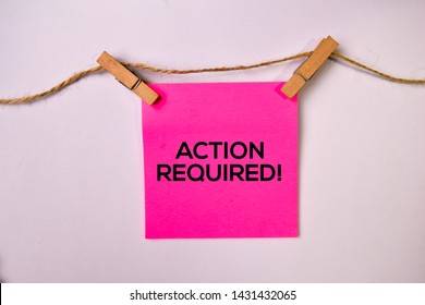 Action Required! on sticky notes isolated on white background.