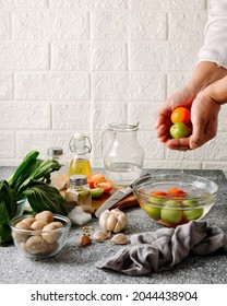 An Action Shot About Tomatoes Being Washed During Preparation Of Cooking Something