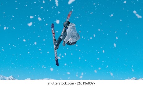 Action shot of an expert freestyle skier taking off a kicker and doing a 360 grab while exploring Vogel, Slovenia. Male skier riding in the scenic wintry mountains of Slovenia does a cool trick.