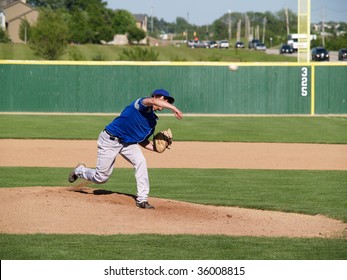 action shot of a high school baseball pitcher winding up to throw the baseball - Powered by Shutterstock