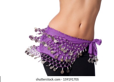 Action shot of the torso of a female belly dancer shaking her hips. She is dressed for rehearsing and practicing belly dance wearing a purple coin belt and black leggings. Isolated on white.