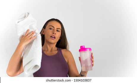 Action Shot Woman Pre Or Post Workout With Shake Bottle And Towel