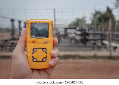 Action Of A Worker Is Using A Portable Gas Detector Device To Testing The Gas Condition Before Entry To Refinery Plant. Safety Action Concept In The Industrial.