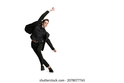 In Action. Young Man In Black Business Suit Dancing Isolated On White Background. Art, Motion, Action, Flexibility, Inspiration And Ad Concept. Flexible Ballet, Contemporary Dancer Weightless Moves