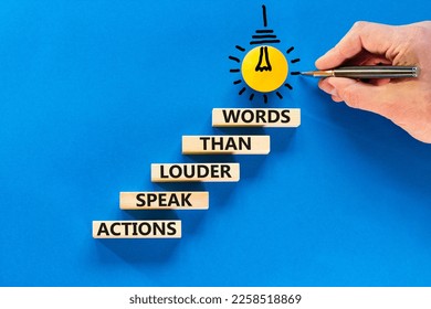 Actions speak louder words symbol. Concept words Actions speak louder than words on wooden blocks. Beautiful blue background. Businessman hand. Business new mindset for results concept. Copy space. - Shutterstock ID 2258518869