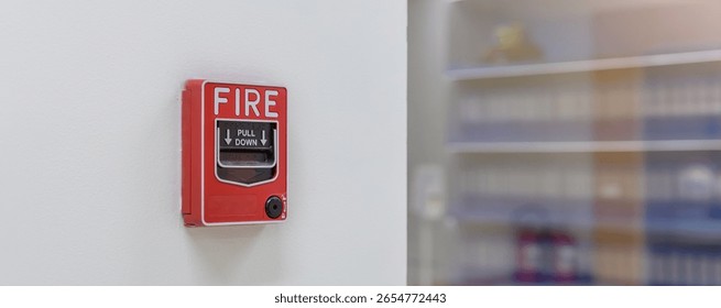 Activate fire alarm trigger system which is installed on granite wall of the building. Fire alarm device that installed on building wall, press the button to activate sound in emergency fire case